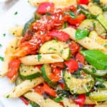 vegan pasta primavera served on a white plate