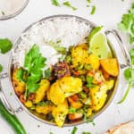 cauliflower sabji in a stainless steel bowl with rice