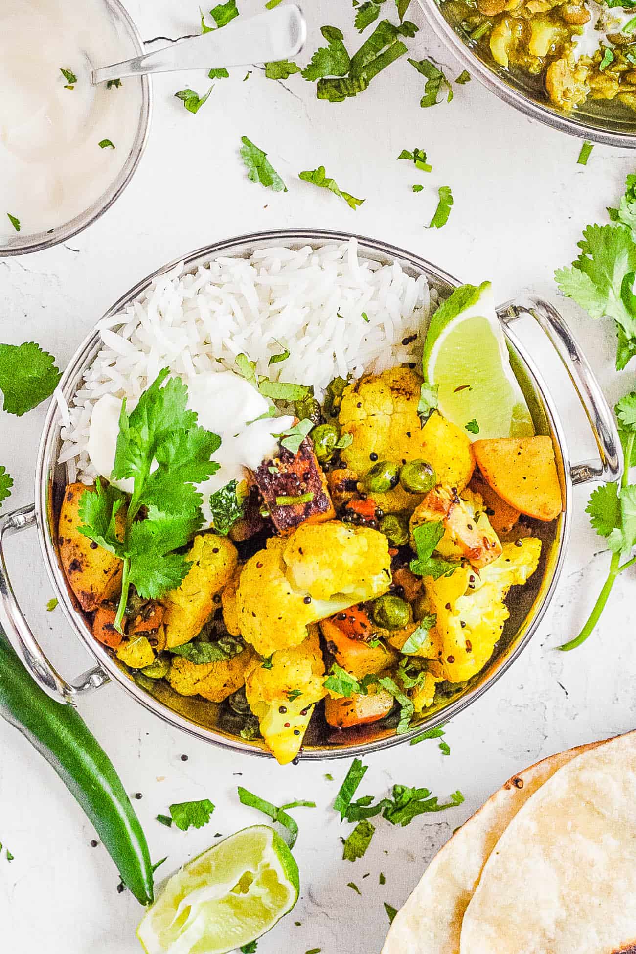 cauliflower sabji in a stainless steel bowl with rice