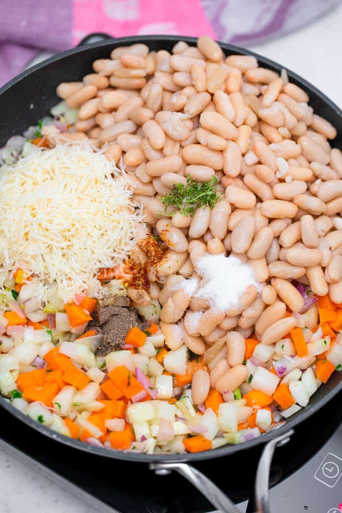 beans veggies and cheese in a pot