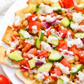 healthy vegetarian greek nachos served on a white plate