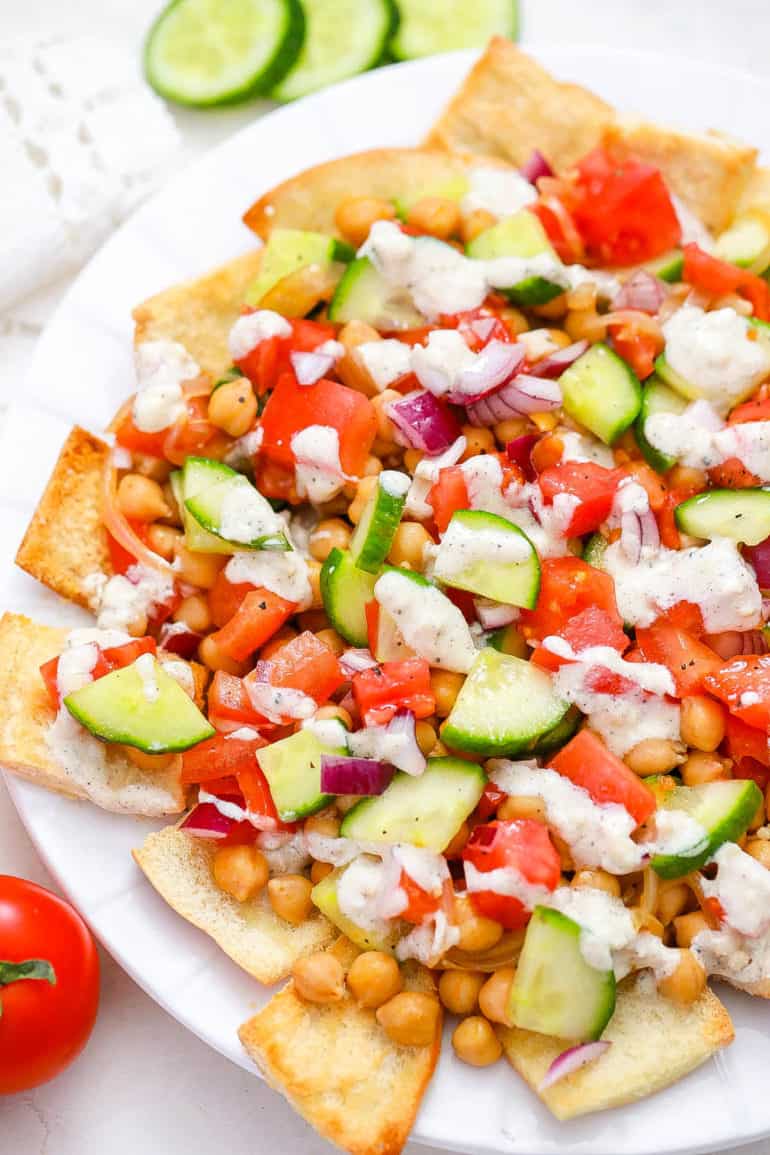 healthy vegetarian greek nachos served on a white plate