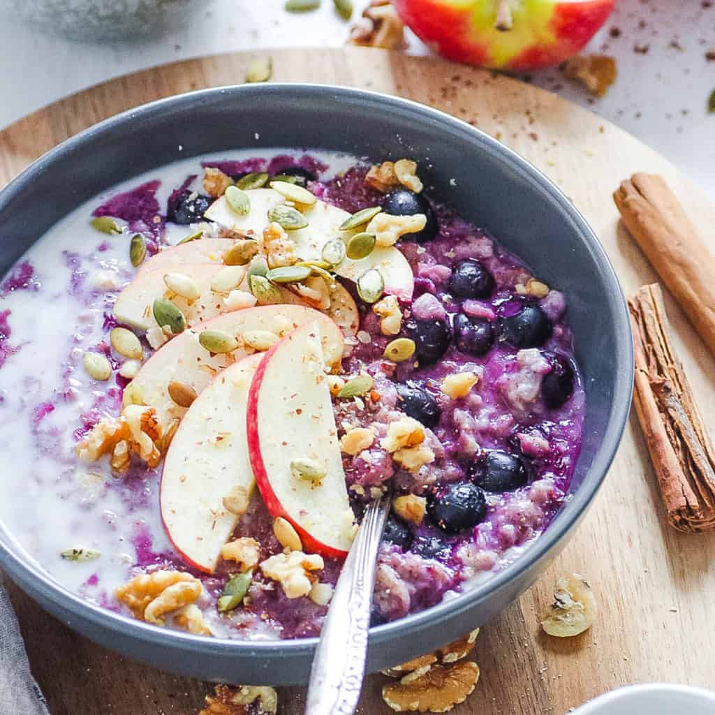 how to make oatmeal taste good - blueberry oatmeal on a wooden cutting board