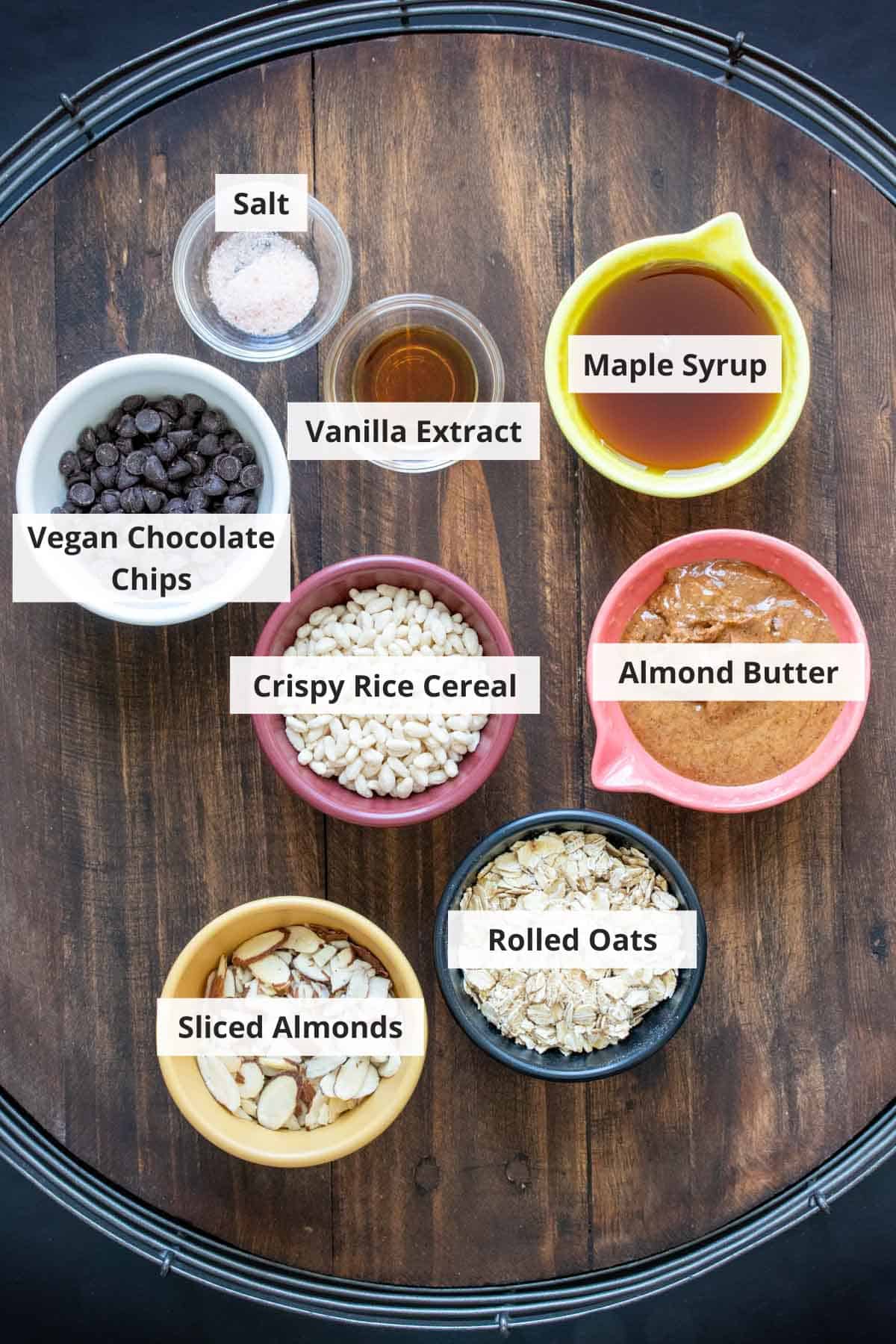 Ingredients for vegan granola bars on a wood background.