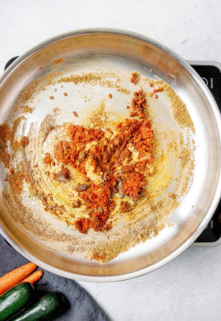 Spices added to a pan with olive oil.