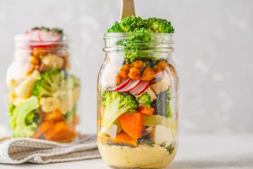 vegan lunch ideas - Healthy Homemade Mason Jar Salad with baked vegetables, hummus, tofu and chickpeas. Healthy food, detox, Clean Eating or vegan concept.