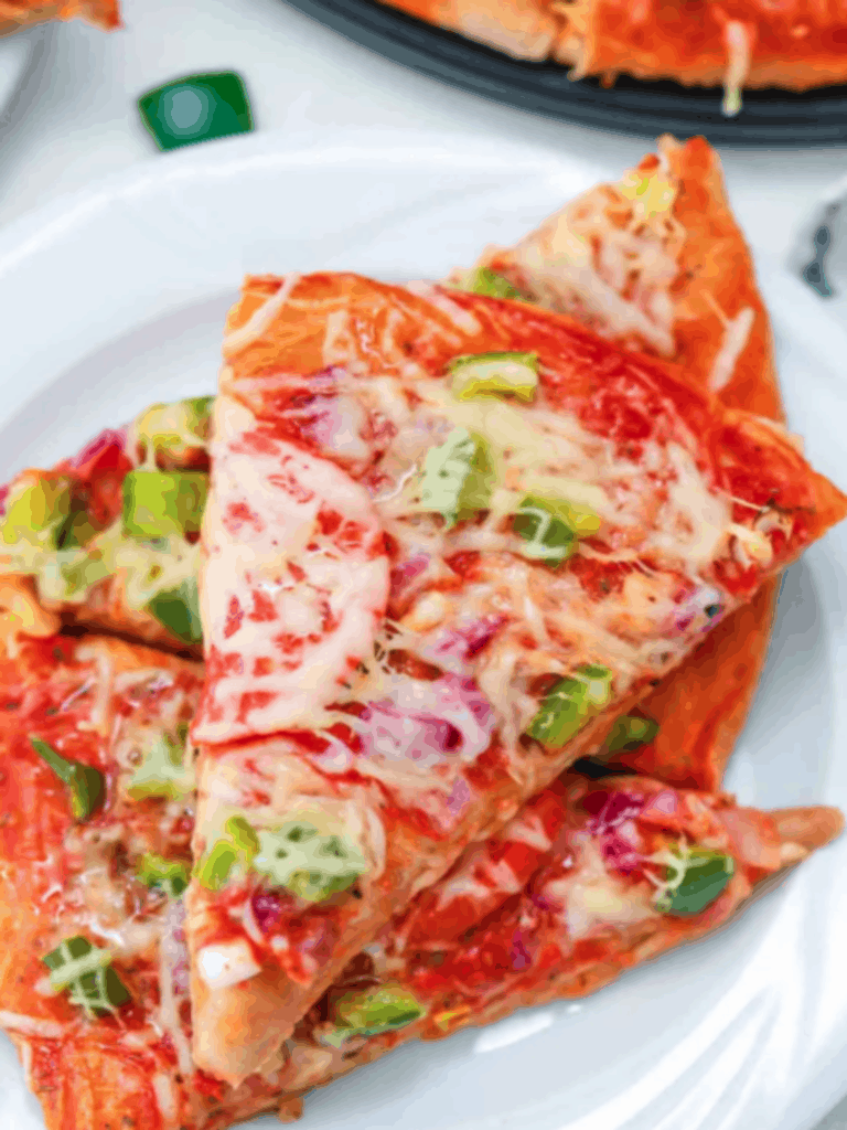 Top view of veggie pizza recipe on white plate