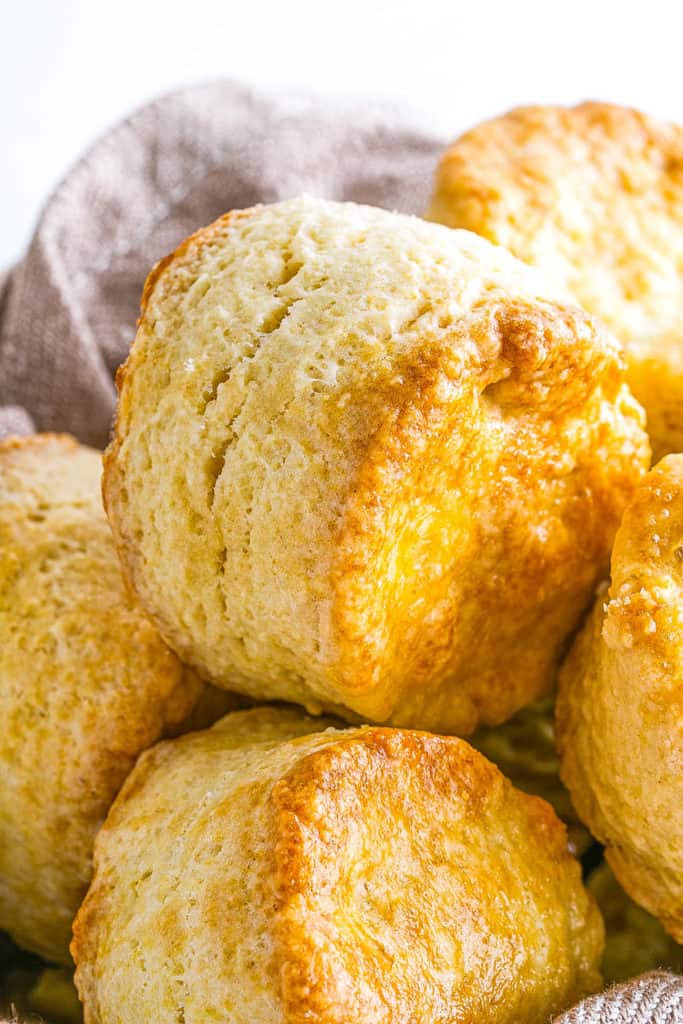 Easy Biscuit Recipe without Baking Powder - biscuits stacked in a bowl and on top of each other