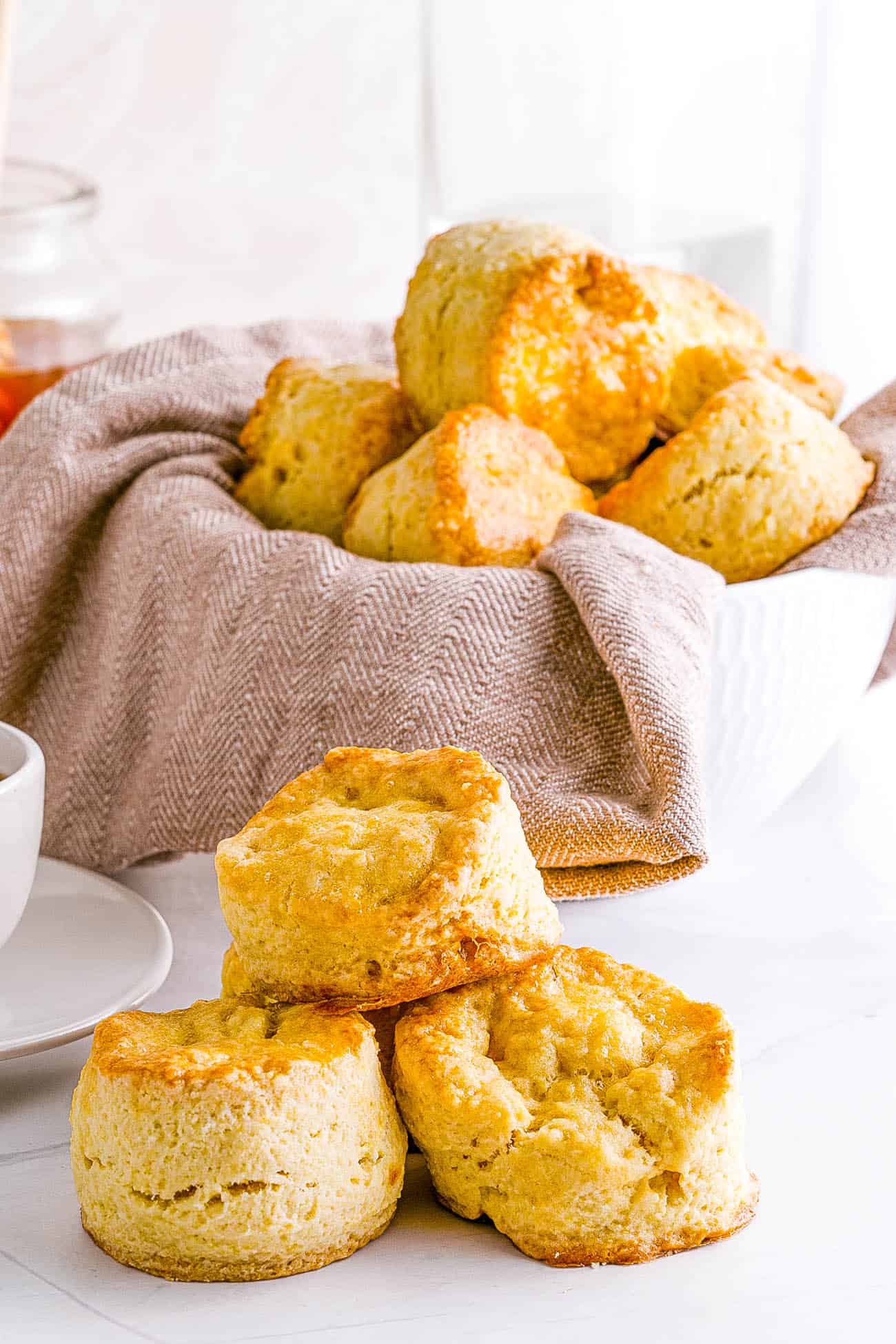 Easy Biscuit Recipe without Baking Powder - biscuits stacked in a bowl and on top of each other
