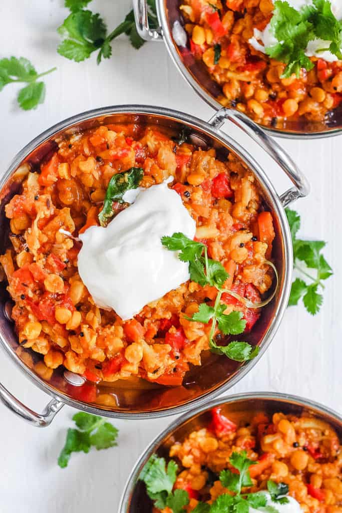 instant pot dal in a stainless steel bowl with a dollop of yogurt on top