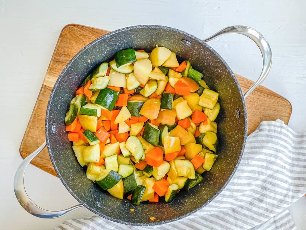 zucchini apples and carrots in a pot