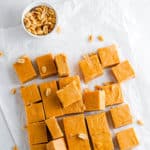 easy microwave peanut butter fudge cut into squares on parchment paper