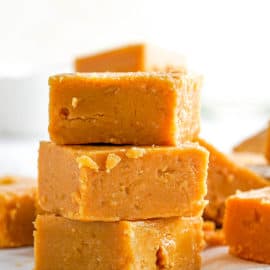 easy microwave peanut butter fudge cut into squares on parchment paper