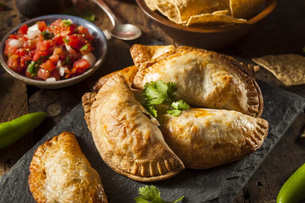 Homemade Stuffed Chicken Empanadas on a Background