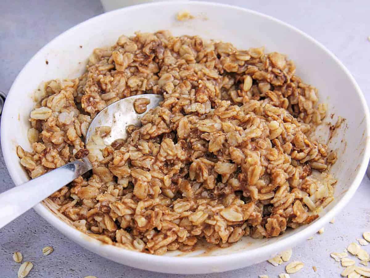 Oatmeal mixed with cocoa powder in a white bowl.