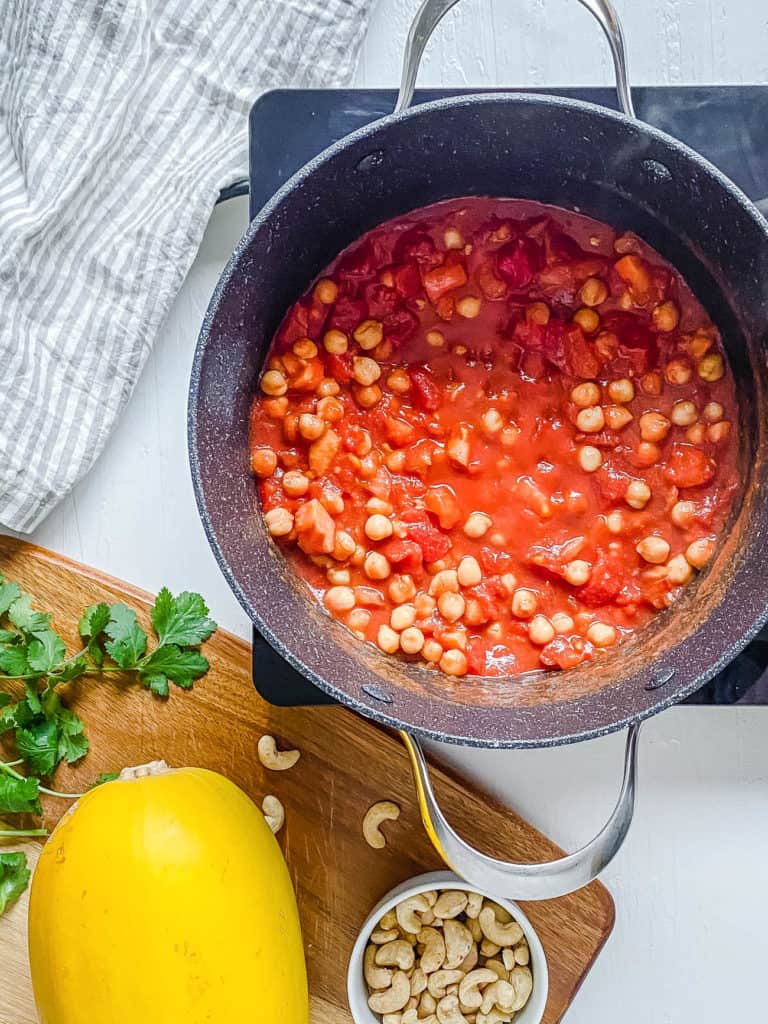 chickpeas and tomatoes cooking in a pot
