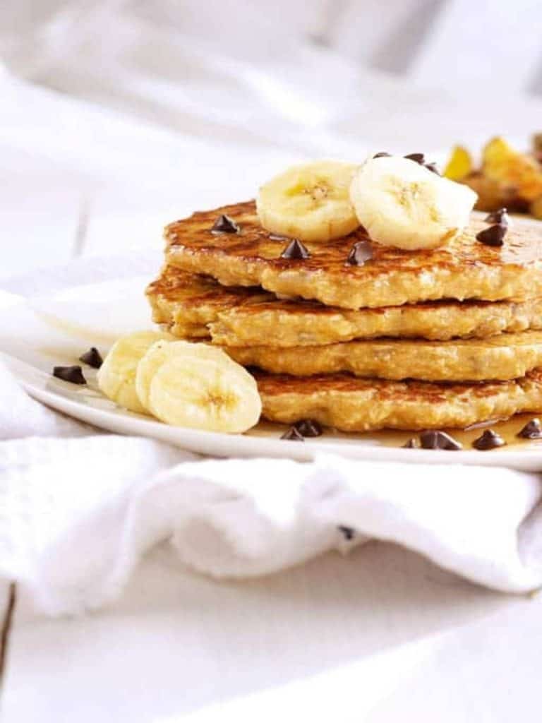 oat flour pancakes on white plate with banana slices