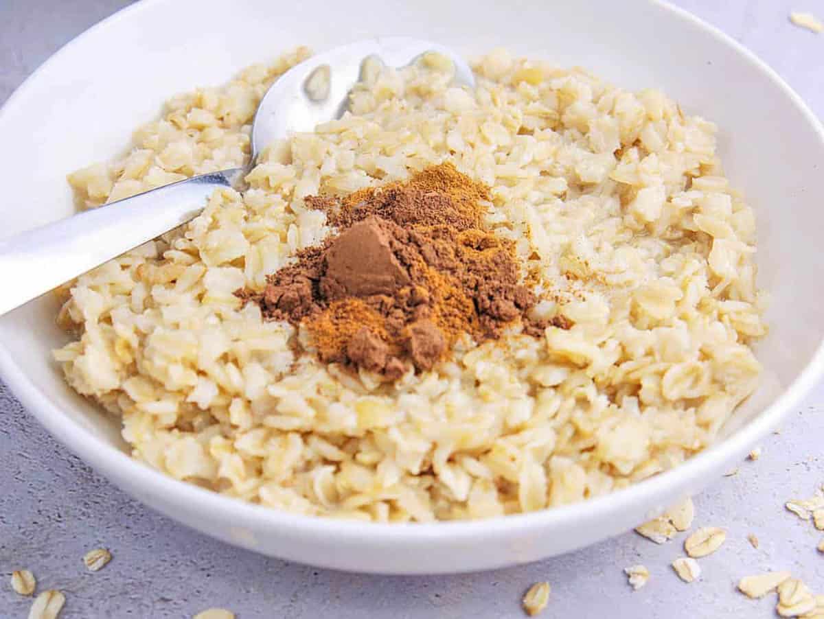 Oatmeal mixed with cocoa powder in a white bowl.