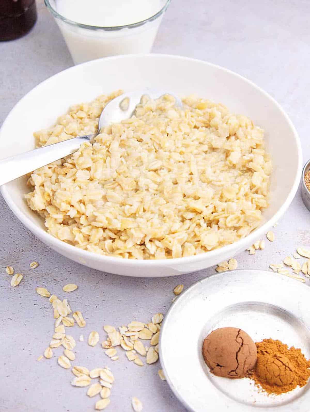 Cooked oats in a white bowl.