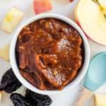 prune baby food puree served in a white bowl