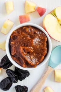 prune baby food puree served in a white bowl