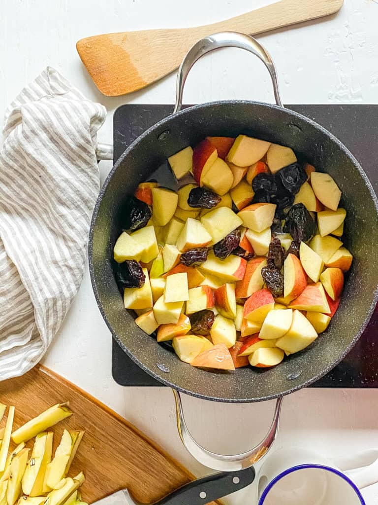apples and prunes cooking in a large pot