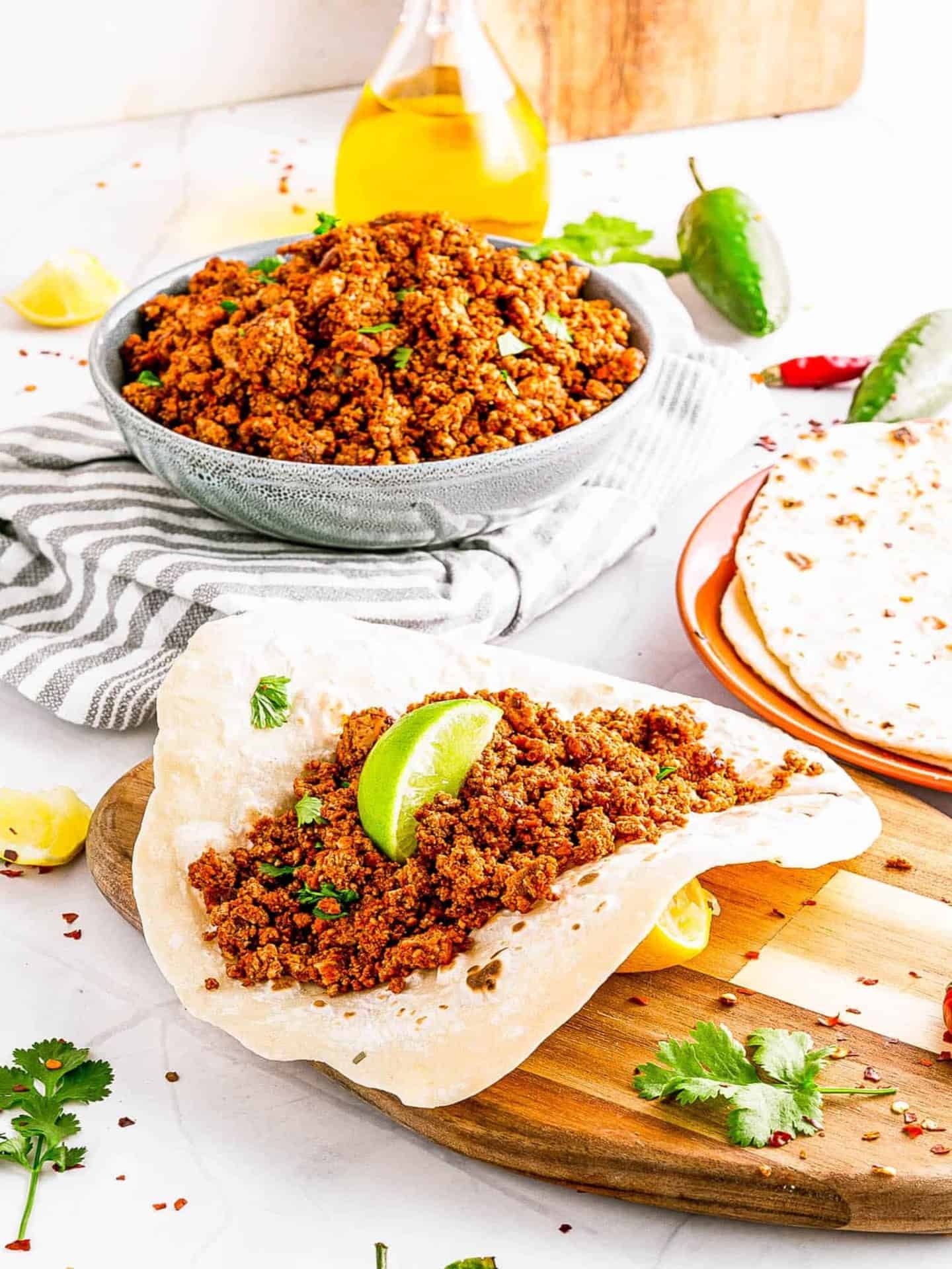 vegan chorizo in bowl with lime and tortilla