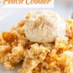 Vegan peach cobbler serving on plate topped with ice cream.