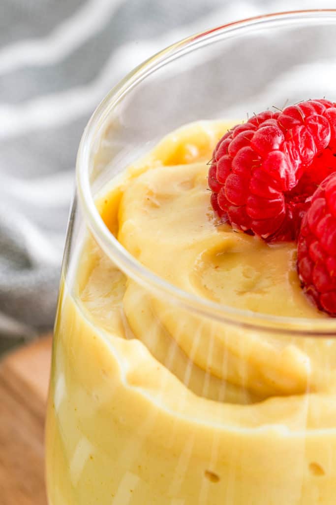 closeup of vegan vanilla pudding topped with fresh berries