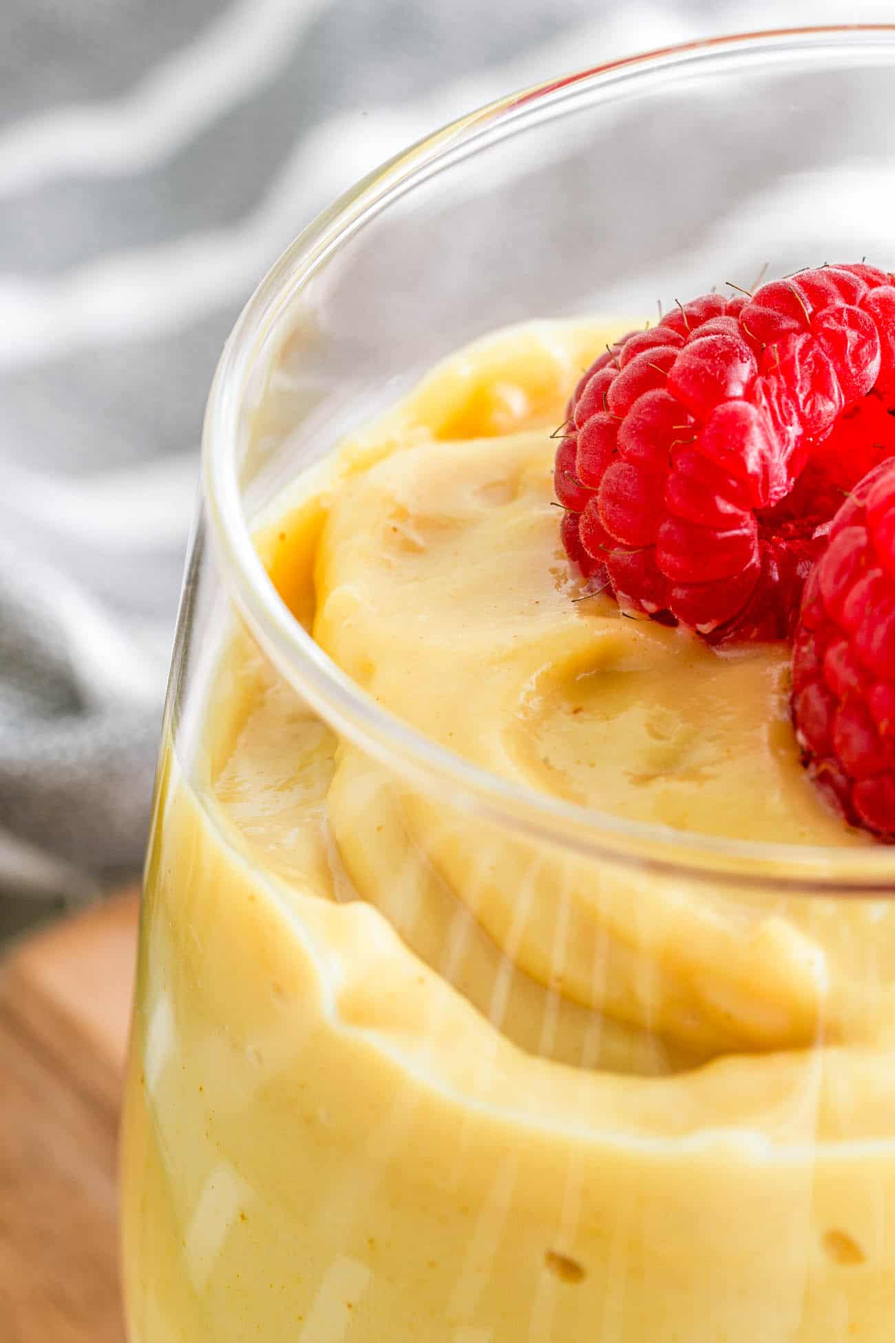 closeup of vegan vanilla pudding topped with fresh berries