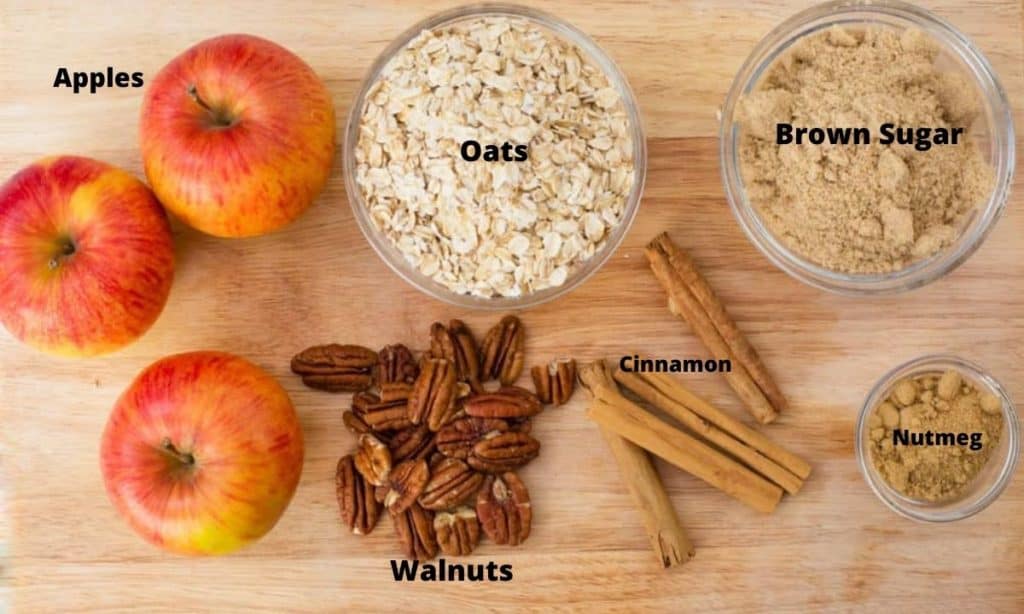 Ingredients for gluten-free apple crisp: apples, oats, brown sugar, cinnamon, nutmeg, walnuts.