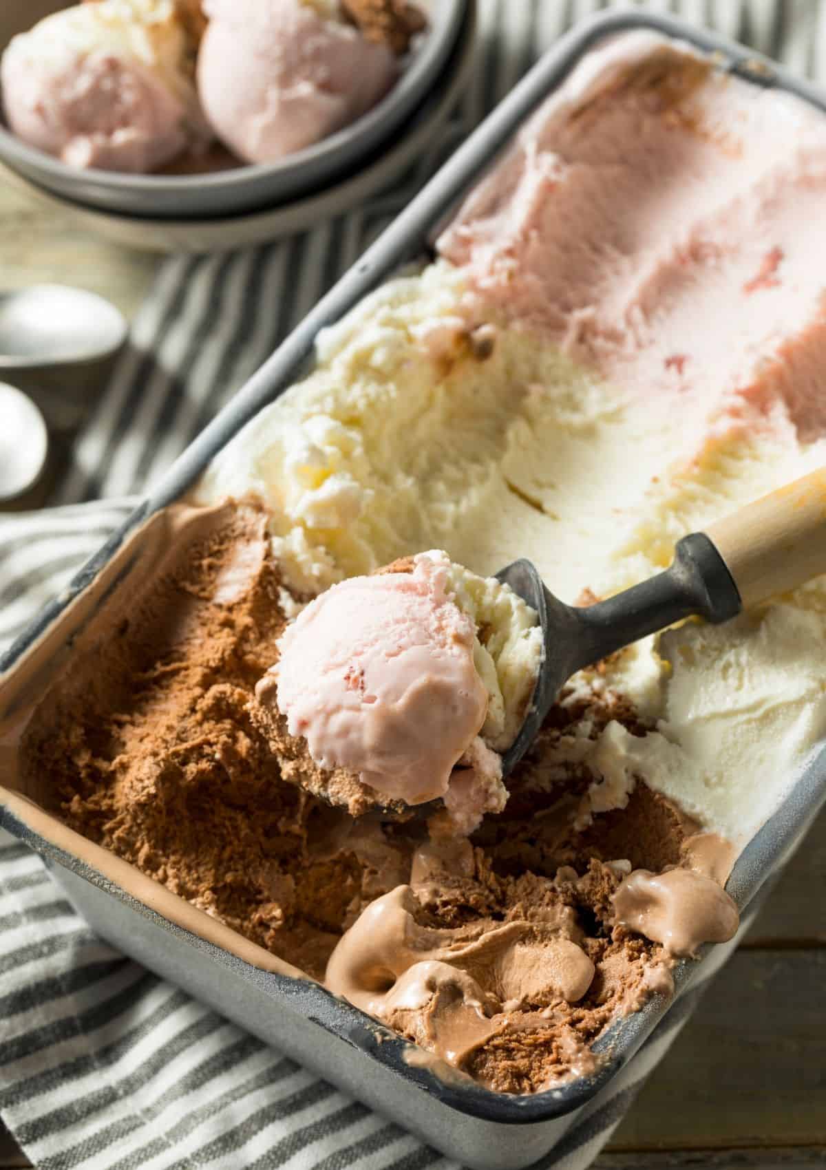 Neapolitan ice cream in 9 inch baking pan, with ice cream scoop. - foods that start with n