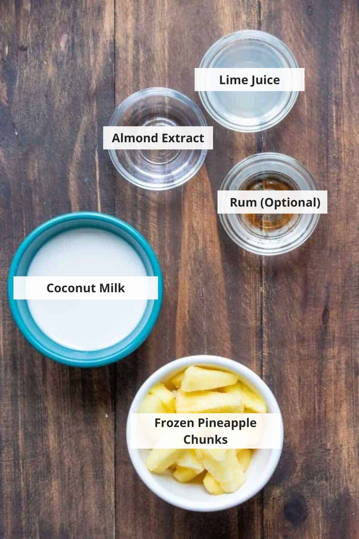 Ingredients for healthy pina colada smoothie on a wood background.