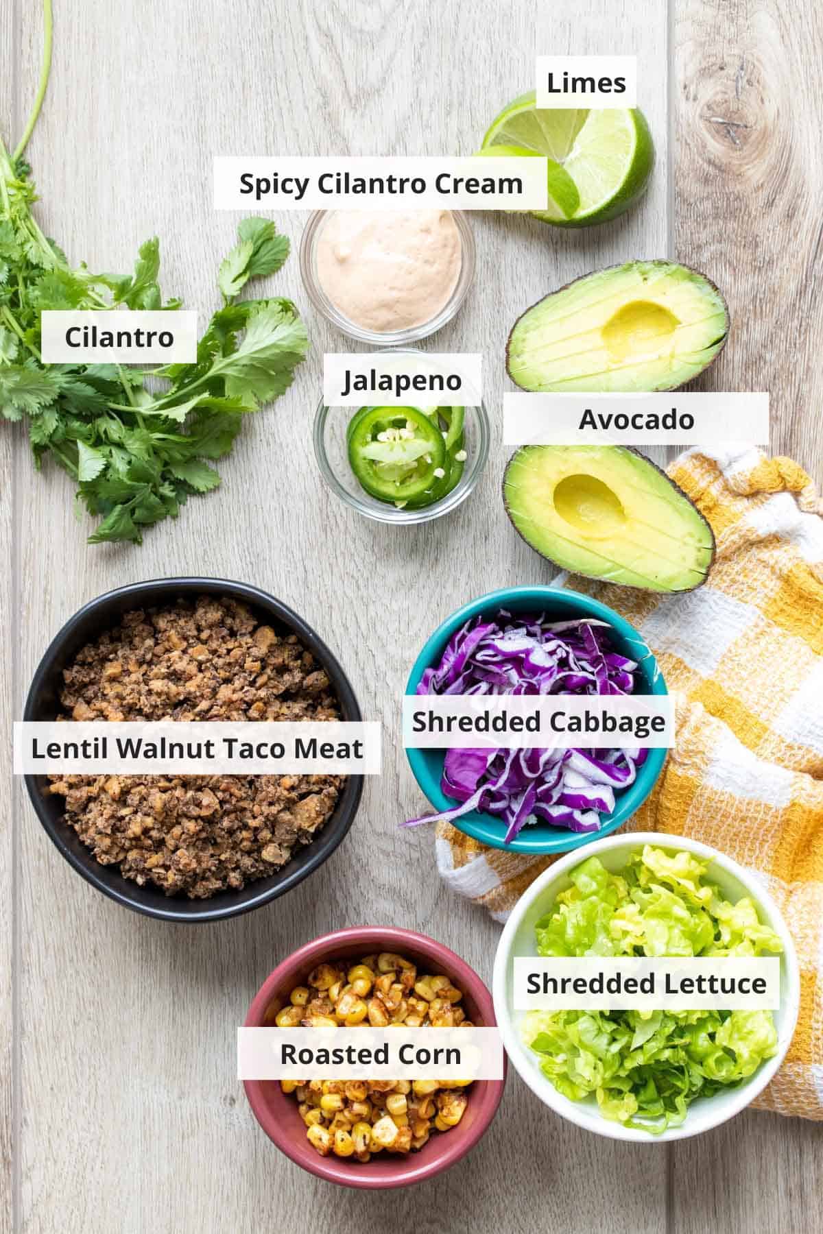 Ingredients for vegan taco salad on a wood countertop.