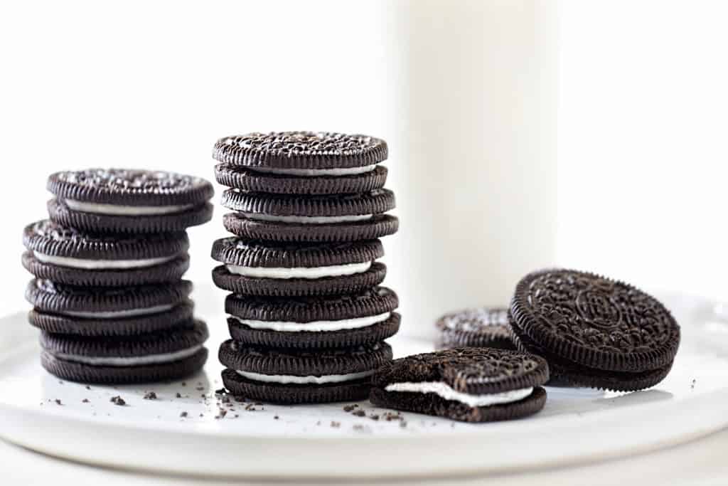 stacked oreo cookies on a white plate - are oreos vegan