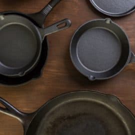 Cast iron skillets on a wooden countertop.