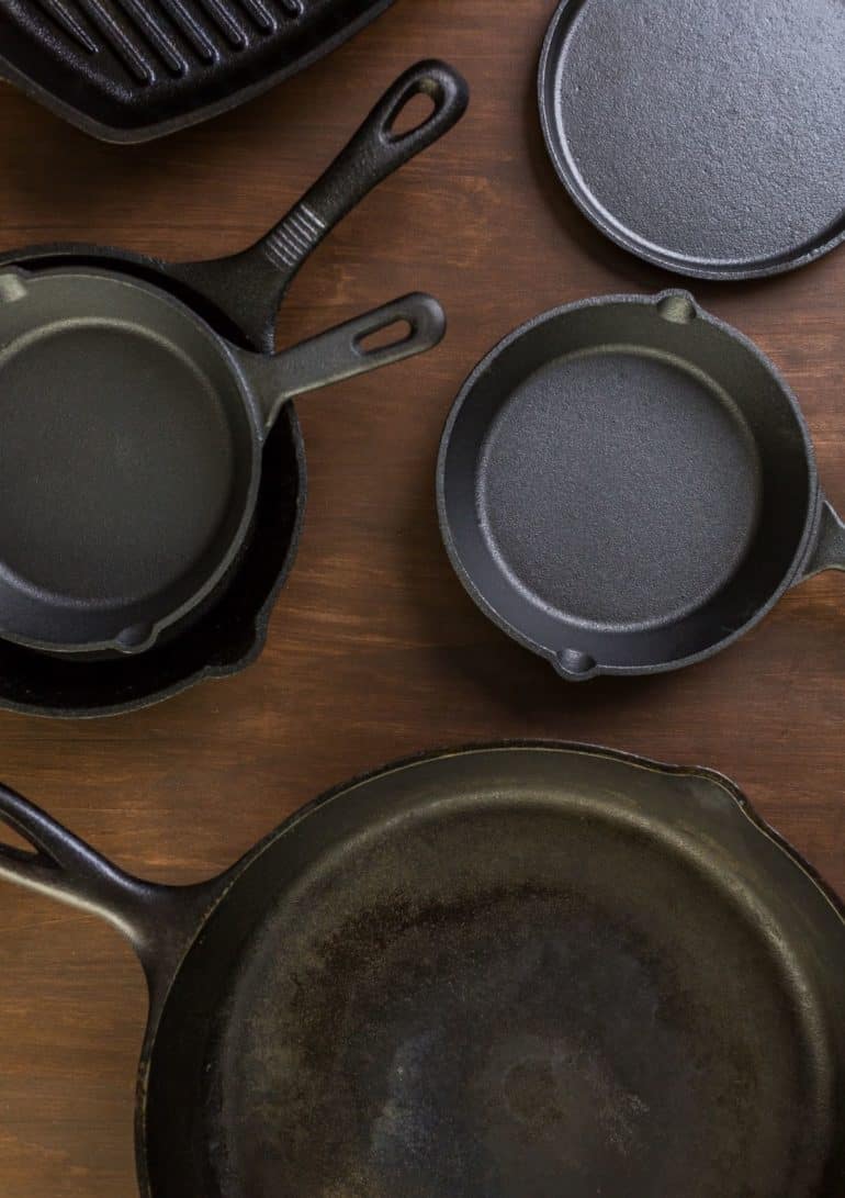 Cast iron skillets on a wooden countertop.