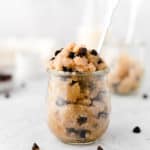 healthy vegan edible cookie dough in a glass jar with a spoon