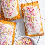 healthy homemade vegan pop tarts with strawberry filling with rainbow sprinkles and coconut yogurt icing