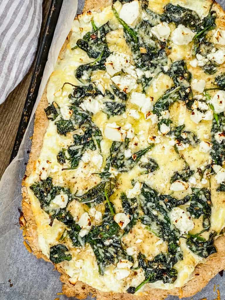 vegetarian florentine pizza - white pizza with spinach and parmesan cheese fresh out of the oven