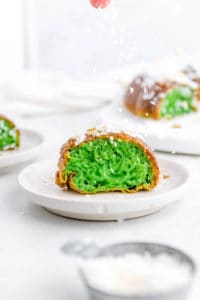 banh bo nuong - Vietnamese honeycomb Cake cut to show green pandan inside, served on a white plate