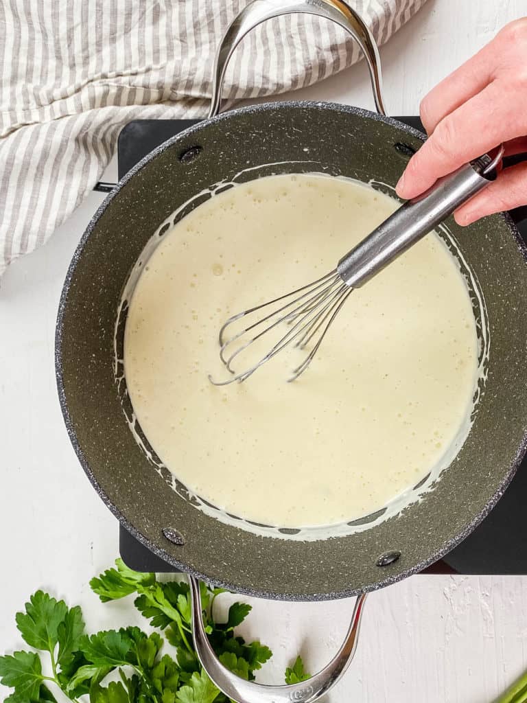 homemade alfredo sauce without heavy cream whisked in a pot