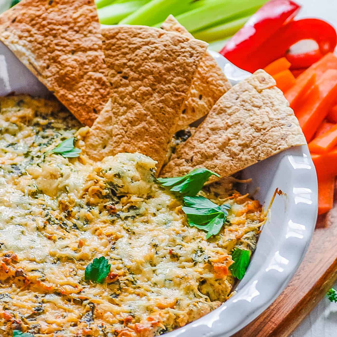 healthy cheese dip - kale dip recipe with pita chips in a white bowl
