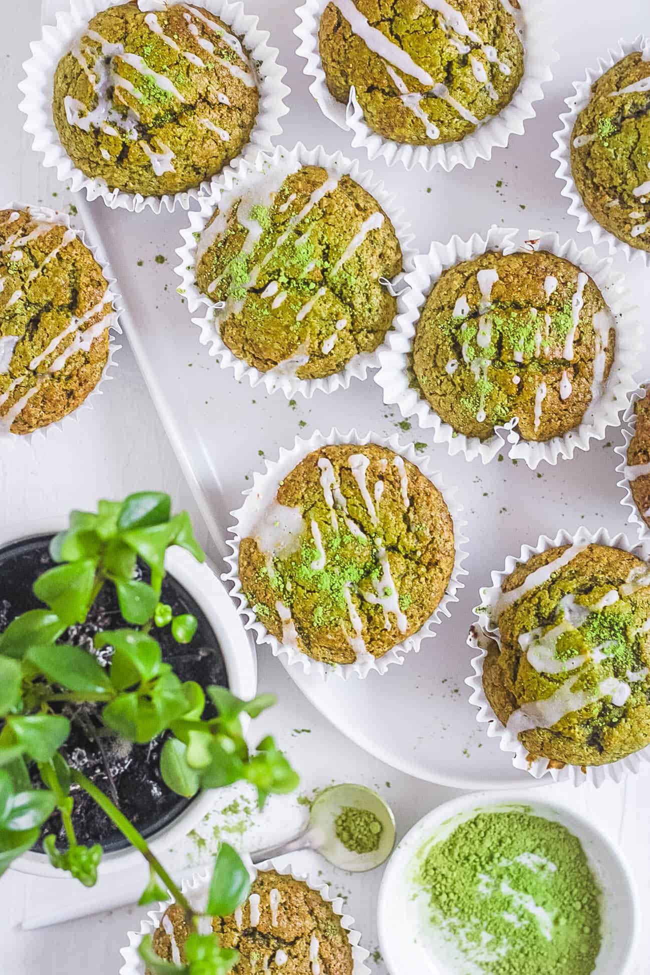 easy healthy matcha muffins recipe on a white plate with lemon frosting - plant based breakfast ideas