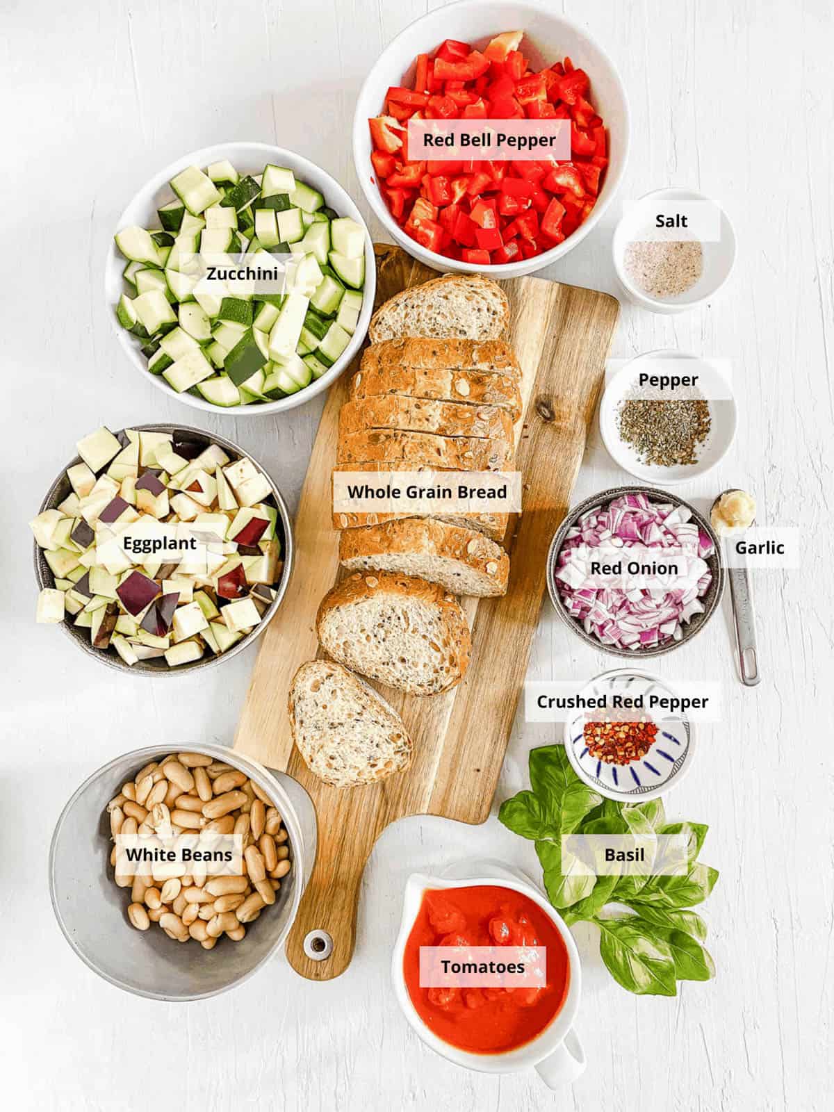 Ingredients for vegan bruschetta recipe on a white background.