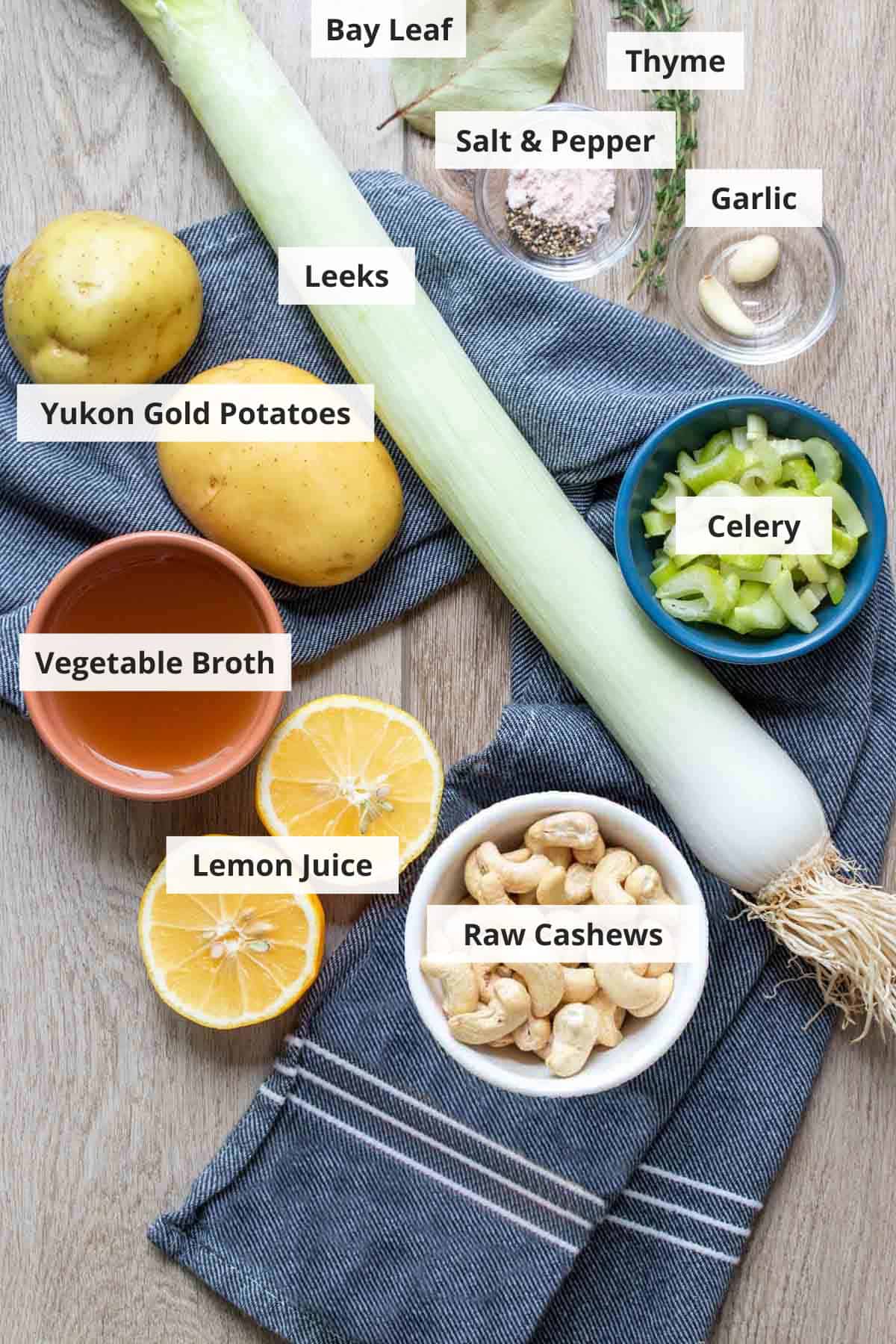 Ingredients for vegan potato leek soup recipe on a wood countertop.