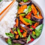 vegan thai basil eggplant recipe served with rice in a white bowl