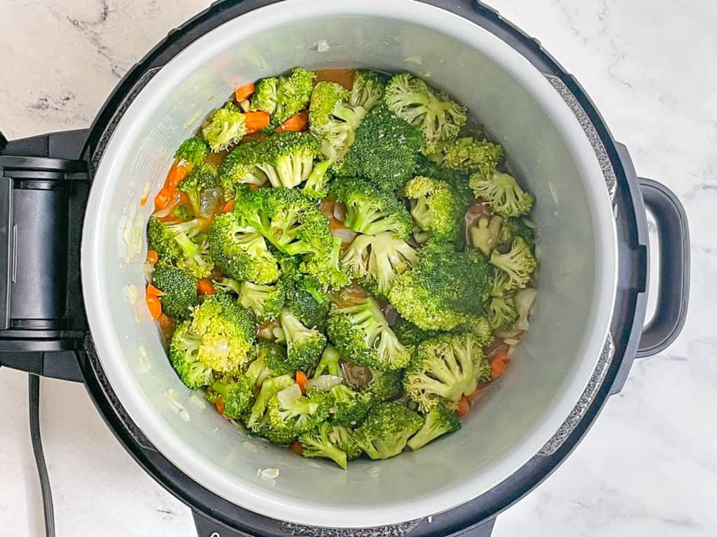 broccoli and veggies added to pot