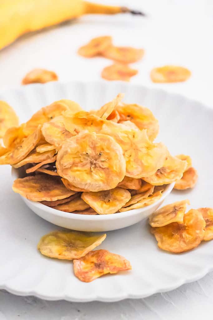 healthy easy air fryer banana chips in a white bowl
