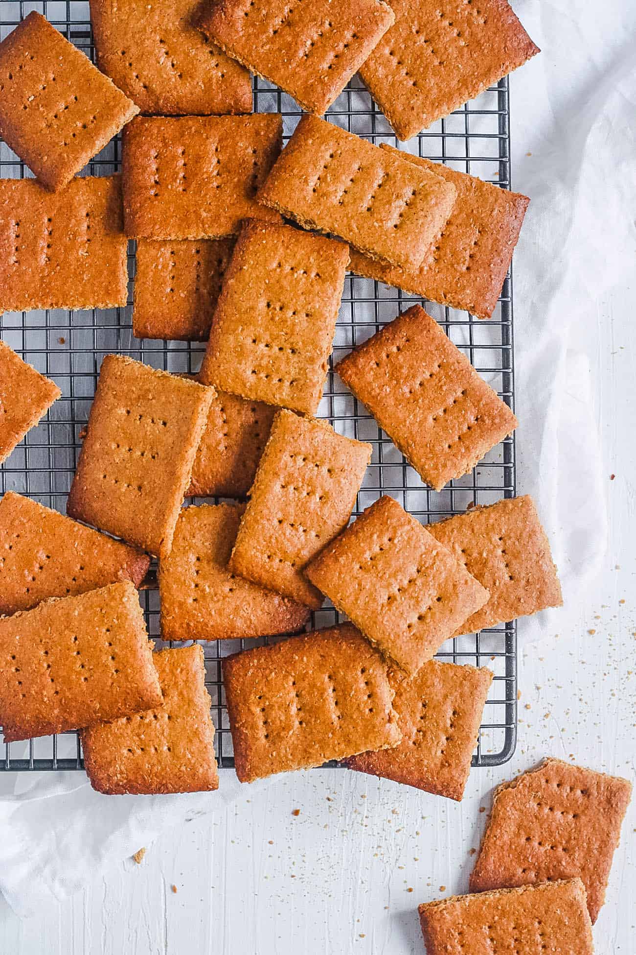 Vegan graham crackers on a wire cooling rack.